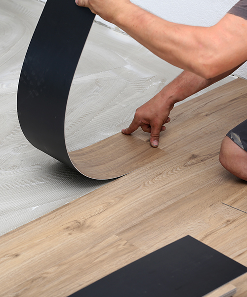 contractor close up installing luxury vinyl floors cincinnati oh
