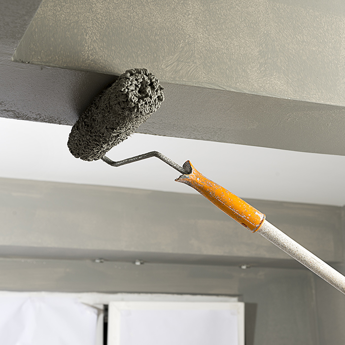 residential property ceiling painting with paint roller close up cincinnati oh