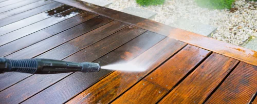closeup of pressure washer washing wooden deck cincinnati oh