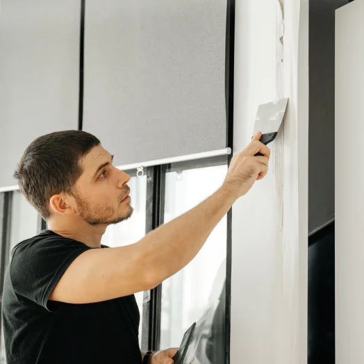 drywall contractor using a spatula to cover a hole on a drywall cincinnati oh